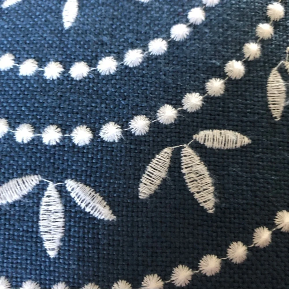 Navy and white embroidered square pillow